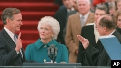 President George Bush raises his right hand as he is sworn into office as the 41st president of the United States. 