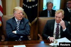 U.S. President Donald Trump, flanked by Deputy Secretary of Defense Patrick Shanahan, holds a cabinet meeting at the White House in Washington, U.S. May 9, 2018.