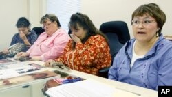 Sexual abuse victim Elsie Boudreau, right, talks, during a news conference in Anchorage, Alaska Friday Oct. 30, 2009, about the Catholic Diocese of Fairbanks' offer to settle sexual abuse claims against priest in Alaska, as abuse victims Norma Ozenna, sec