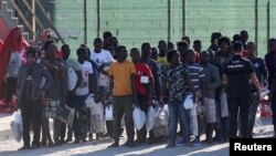 Migrants are seen after disembarking a rescue boat at the port of Malaga, southern Spain, Sept. 23, 2018. 