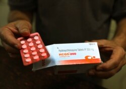 FILE - A chemist displays hydroxychloroquine tablets in New Delhi, India, April 9, 2020.