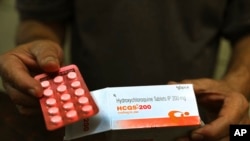 FILE - A chemist displays hydroxychloroquine tablets in New Delhi, India, April 9, 2020.