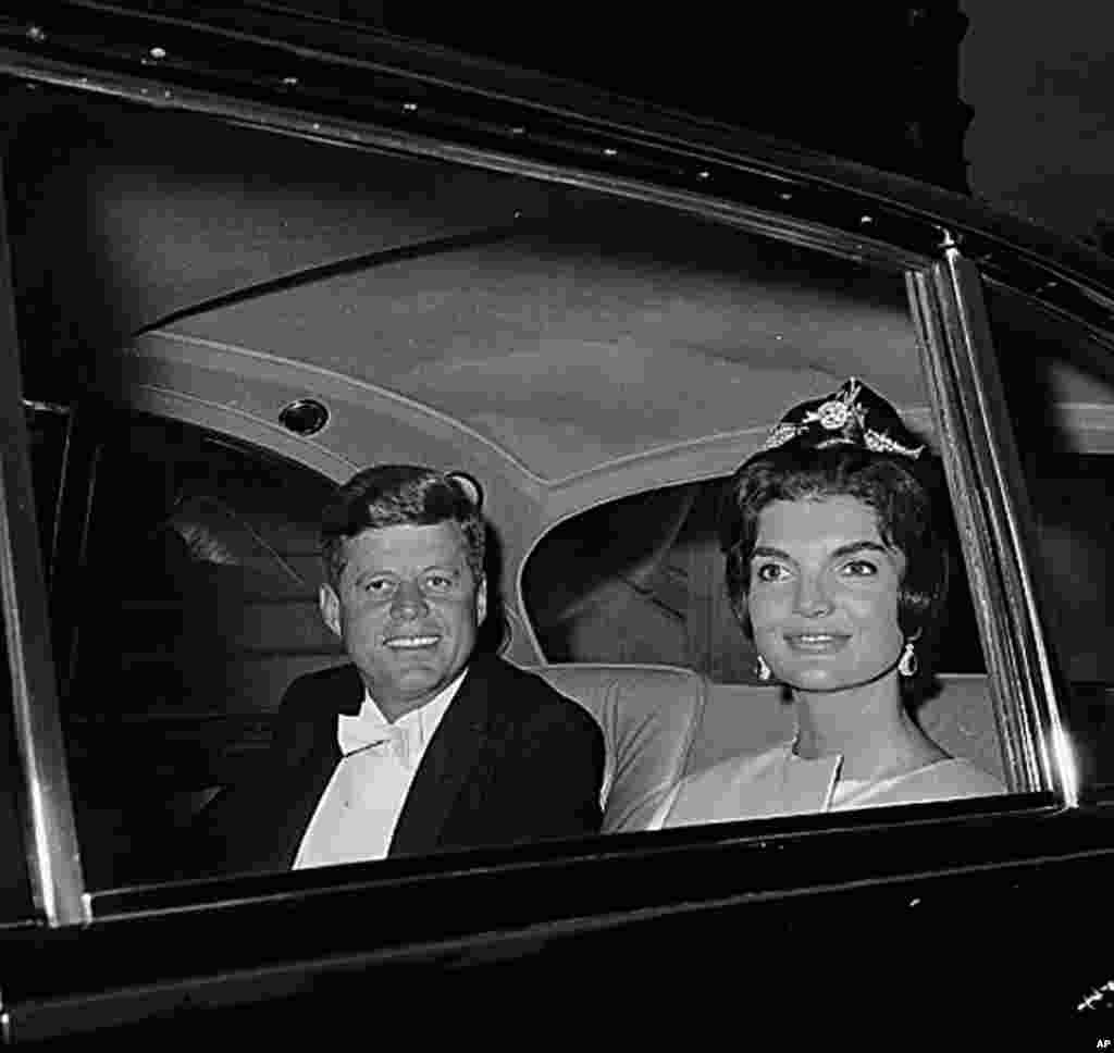 U.S. President John F. Kennedy and first lady Jacqueline Kennedy are shown in a car as they leave their residence at Quai D'Orsay, Paris, for a state dinner in the Hall of Mirrors in Versailles, France, June 1, 1961. (AP Photo)