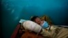 FILE - Rohingya refugee Yasin Arfat, 6, who suffers from diphtheria, lays on a bed at a Medecins Sans Frontieres (MSF) clinic near Cox's Bazar, Bangladesh.