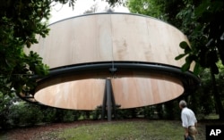 A man visits the installation by architect Javier Corvalan at the Vatican pavilion, at the Biennale International Architecture exhibition, in Venice, Italy, May 23, 2018. The Vatican participated for the first time the Biennale of architecture, having successfully tested the waters at the contemporary art fair in 2013 and 2015. This time, the Holy See entrusted world-renown architects to create chapels in a wooded area on an island in the Venetian lagoon.