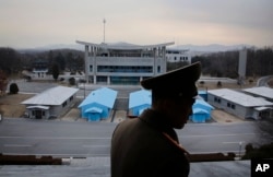 FILE - North Korean People's Army Lt. Col. Nam Dong Ho is silhouetted against the truce village of Panmunjom at the Demilitarized Zone (DMZ) which separates the two Koreas. The North Korean army colonel who defected, who was involved in espionage efforts at the Reconnaissance General Bureau, defected last year.