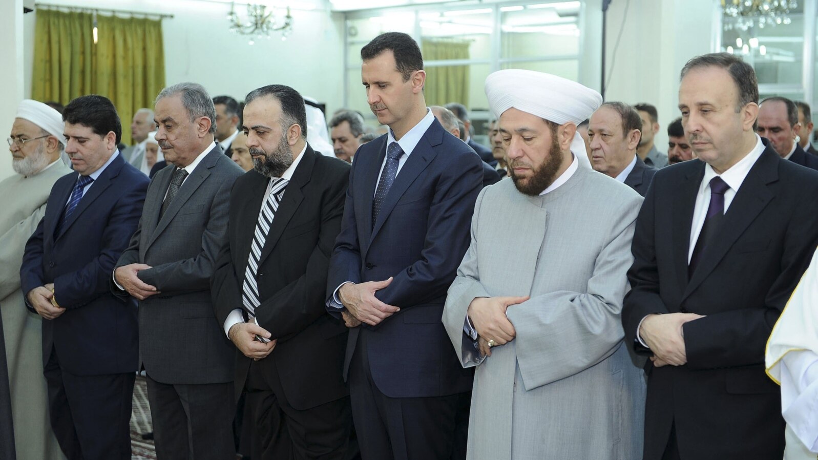 Syria's President Bashar al-Assad (3nd R ) attends Eid Al Fitr prayers at al-Hamad mosque in Damascus, August 19, 2012.