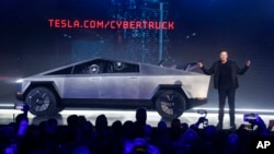 Tesla CEO Elon Musk introduces the Cybertruck at Tesla's design studio Thursday, Nov. 21, 2019, in Hawthorne, Calif. Musk is taking on the workhorse heavy pickup truck market with his latest electric vehicle. (AP Photo/Ringo H.W. Chiu)