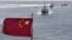 In this July 20, 2012 photo, Chinese fishing boats sail in the lagoon of Meiji reef off the island province of Hainan, a small, remote island in the South China Sea that is also claimed by Vietnam.