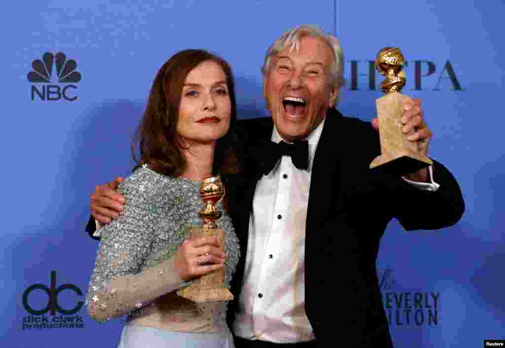 Actress Isabelle Huppert and producer Paul Verhoeven pose backstage with their Golden Globe awards for Best Actress in a Motion Picture - Drama and Best Motion Picture - Foreign Language for "Elle," Jan 8, 2017.