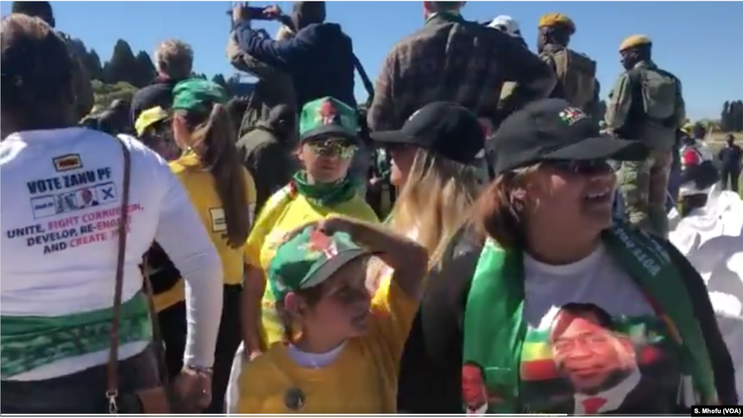 Some of the Zimbabweans following proceedings at the Zanu PF's "white interface rally," July 21, 2018, in Harare where President Emmerson Mnangagwa was addressing the crowd.