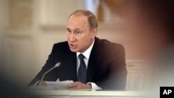 FILE - Russian President Vladimir Putin chairs a meeting of the Council for Interethnic Relations and the Council for the Russian Language at the Kremlin in Moscow, May 19, 2015.