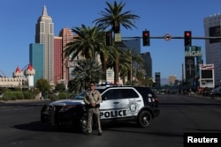 A police officer stands watch along a portion of Las Vegas Boulevard.