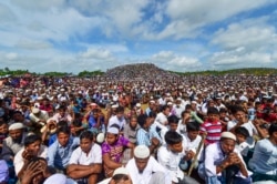 FILE - Rohingya refugees are seen gathered for a ceremony to mark the second anniversary of their flight from Myanmar, at the Kutupalong refugee camp in Ukhia, Bnagladesh, Aug. 25, 2019.