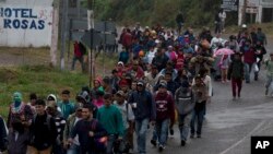 Honduran migrants walk along the roadside through Esquipulas, Guatemala, as they make their way toward the U.S. border, Jan. 16, 2019.