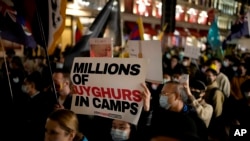 Demonstrators supporting Tibetans, Uyghurs and Hong Kongers march along Regent Street towards the Chinese Embassy in London on October 1, 2021. (Matt Dunham/Associated Press)