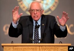 FILE - Then-Democratic presidential candidate Sen. Bernie Sanders, I-Vt., speaks at Georgetown University in Washington, Nov. 19, 2015. Sanders' plan to slow down the impact of climate change included a pledge to cut U.S. carbon emissions.