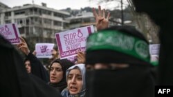 FILE - People hold signs reading "Stop executions in Egypt" during a demonstration against death penalties in Egypt, in front of the Egyptian consulate in Istanbul, March 2, 2019.