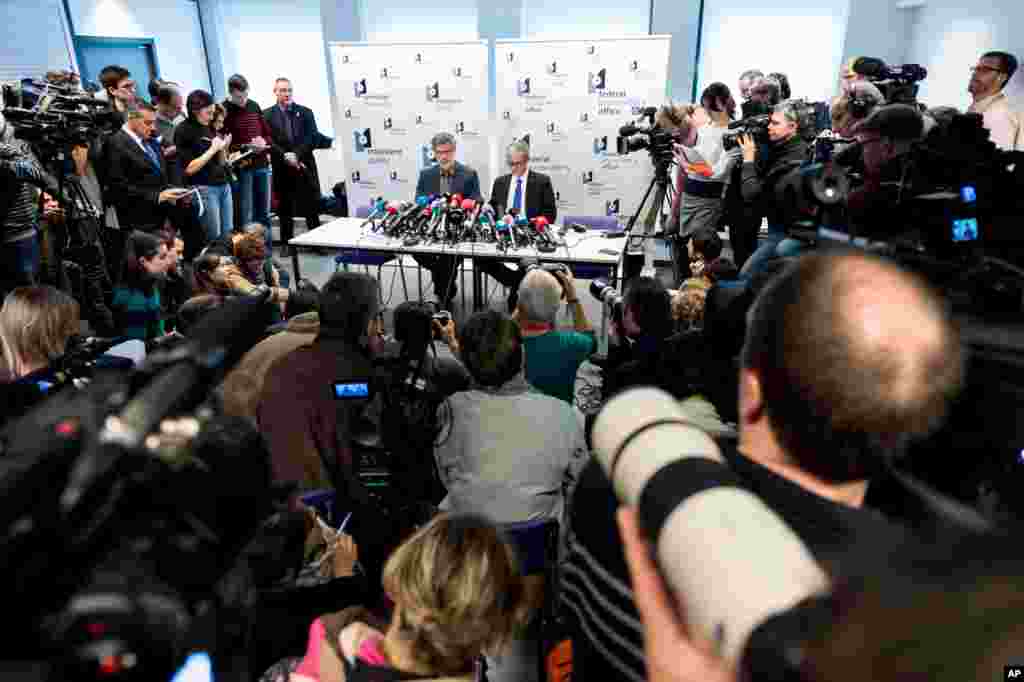 Belgian federal magistrates Eric Van Der Sypt (left) and Thierry Werts address the media on the anti-terror raids in several Belgian cities, at the Belgian Federal Prosecutor&#39;s office in Brussels, Belgium, Jan. 16, 2015.