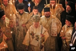 Ecumenical Patriarch Bartholomew I, center, the spiritual leader of the world's Orthodox Christians, leads the Easter Resurrection Service outside the Patriarchal Cathedral of St. George in Istanbul, early Sunday, April 16, 2017.