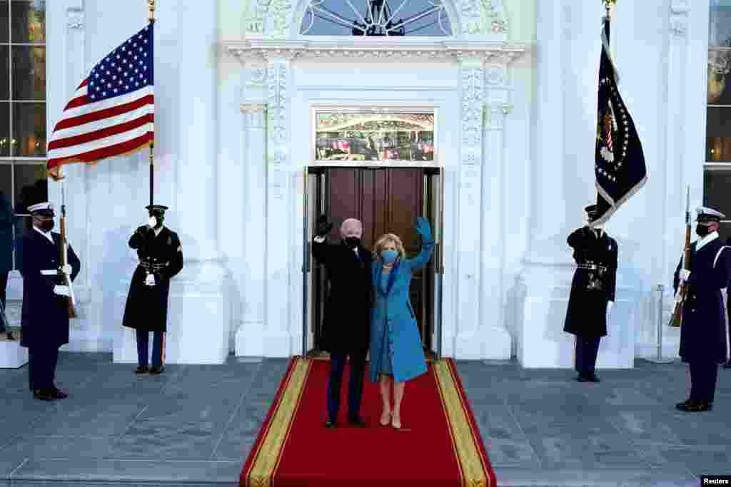 President Joe Biden and first lady Jill Biden wave as they arrive at the North Portico of the White House in Washington, D.C.