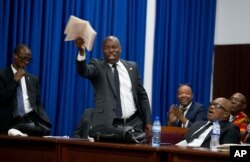 Lawmaker Jean Marcel Lumérant speaks in favor of starting impeachment proceedings against Haitian President Jovenel Moise, as lawmakers debate in Parliament in Port-au-Prince, Haiti, Wednesday, Aug. 21, 2019.