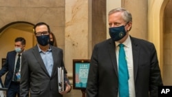 White House chief of staff Mark Meadows, right, and Treasury Secretary Steven Mnuchin arrive at the office of House Speaker Nancy Pelosi at the Capitol to resume talks on a COVID-19 relief bill, Aug. 1, 2020, in Washington.