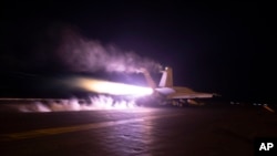 This image provided by the U.S. Navy shows an aircraft launching from USS Dwight D. Eisenhower in the Red Sea, Jan. 22, 2024. The U.S. and British militaries bombed multiple targets in eight locations used by the Iranian-backed Houthis in Yemen on Monday night.