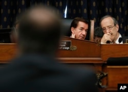 Chairman Rep. Ed Royce, R-Calif., center, talks with Ranking Member Rep. Eliot Engel, D-NY., right, as they listen to testimony by Secretary of State Mike Pompeo, left, at the House Foreign Affairs Committee hearing on Capitol Hill in Washington, May 23, 2018.