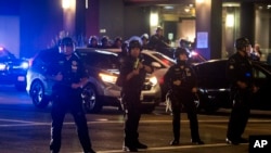 Police officers clear the streets May 31, 2020, in Los Angeles, during protests over the death of George Floyd, who died May 25 after he was pinned at the neck by a Minneapolis police officer. 