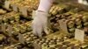 FILE - An employee takes out chocolate truffles at a shop.