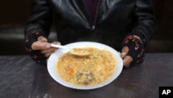 A man eats his soup during "La Porciuncula," a religious event where Franciscans monks serve food to the poor, at the Los Descalzos Convent in Lima, Peru, Aug. 2, 2017.