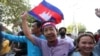 FILE - Rong Chhun, an environment activist, waves a Cambodian national flag after being released from the Correctional center in Phnom Penh, Cambodia, on November 12, 2021. (LICADHO/Raksmey Sok Handout via REUTERS)