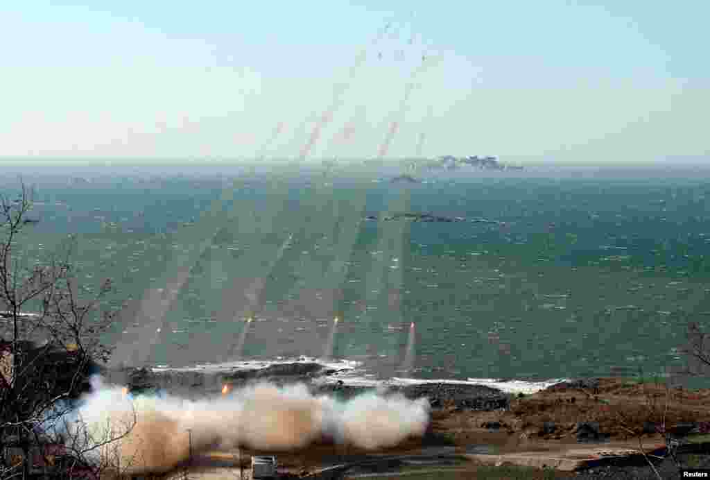 North Korea&#39;s artillery sub-units, whose mission is to strike Daeyeonpyeong island and Baengnyeong island of South Korea, conduct a live shell firing drill to examine war fighting capabilities in the western sector of the front line, March 14, 2013.