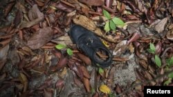 Clothes are photographed near abandoned human trafficking camp in the jungle close the Thailand border 
