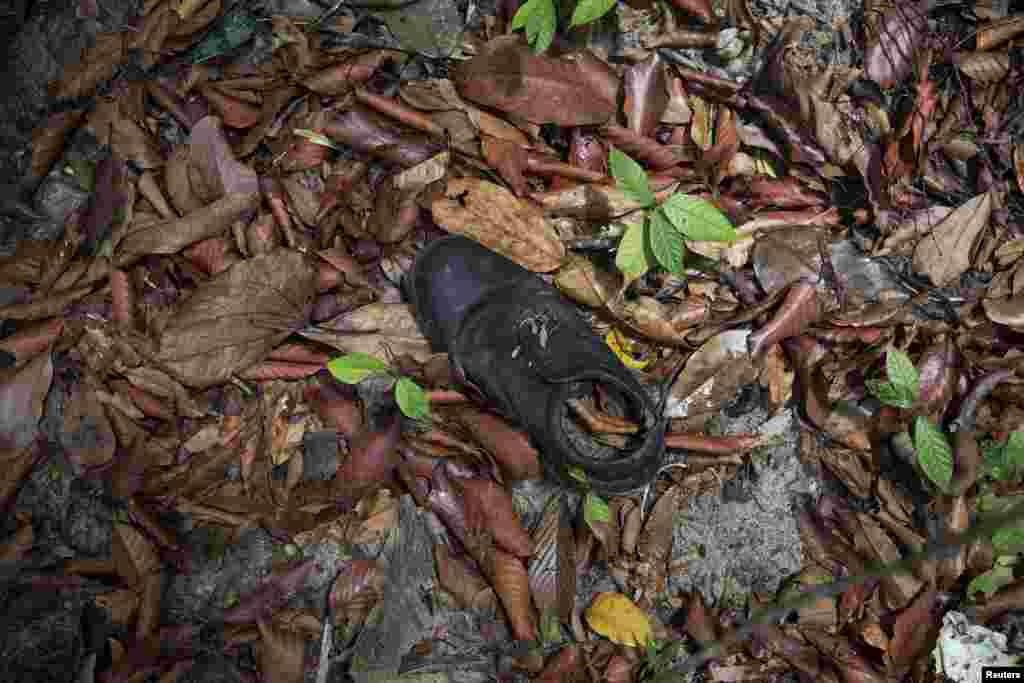 Pakaian ditemukan dekat kamp perdagangan manusia yang ditelantarkan di hutan dekat perbatasan Thailand di Bukit Wang Burma, Malaysia utara (26/5). ​(Reuters/Damir Sagolj)