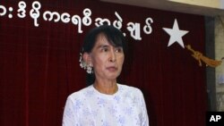 Myanmar pro-democracy leader Aung San Suu Kyi talks to reporters during a press conference at the headquarters of her National League for Democracy party Monday, April 30, 2012, in Yangon, Myanmar. Suu Kyi said she and other lawmakers in her opposition p