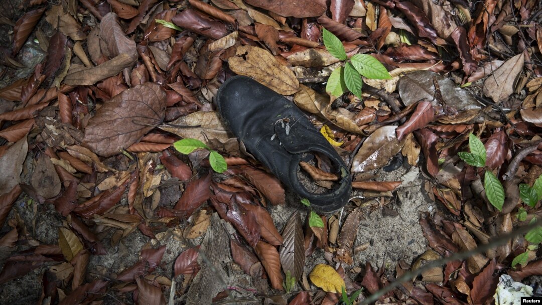 Clothes are photographed near abandoned human trafficking camp in the jungle close the Thailand border 