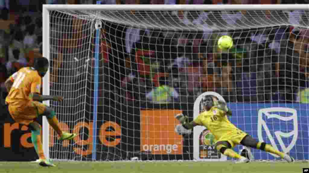 Ivory Coast's captain Didier Drogba, left, makes a penalty shootout against Zambia's goalkeeper Kennedy Mweene during their Africa Cup of Nations final soccer match at the Stade de l'Amitie in Libreville, Gabon, Sunday Feb. 12, 2012.