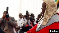 Retired Commander of Zimbabwe Defence Forces (ZDF) General Constatino Chiwenga is congratulated by Chief Justice Luke Malaba after taking an oath of office as vice president at State House in Harare, Dec. 28, 2017. 