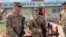 U.S. soldiers stand guard during the hand over ceremony of Qayyarah Airfield, Iraqi Security Forces, in the south of Mosul, Iraq  early Friday, March 27, 2020. Iraq's military on Thursday said at least two rockets hit inside Baghdad's heavily…
