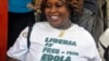 A woman smiles as she celebrates Liberia being an Ebola-free nation in Monrovia, Liberia, Saturday, May 9, 2015. Liberia is now free of Ebola after going 42 days — twice the maximum incubation period for the deadly disease — without any new cases, the World Health Organization announced on Saturday.(AP Photo/ Abbas Dulleh)