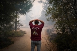 Peter Koleckar reacts after seeing multiple homes burned in his neighborhood after the CZU August Lightning Complex Fire passed through, in Bonny Doon, Calif., Aug. 20, 2020.