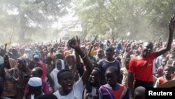 FILE - Sudanese civilians protest against United Nations Hybrid Operation in Darfur (UNAMID) exit in Zalenjei, West Darfur, Sudan, Dec. 29, 2020.