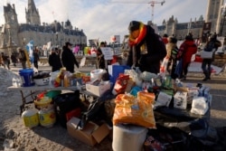 A demonstrator chooses a snack at a free food table in front of Parliament Hill as truckers and their supporters continue to protest against COVID-19 vaccine mandates in Ottawa, Ontario, Canada, Jan. 31, 2022.