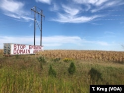 A Stop Eminent Domain Abuse sign is posted along a major highway near Iowa's capital of Des Moines, Sept. 9, 2018. Several Iowans say eminent domain was illegally granted in order for the controversial Dakota Access Pipeline to be installed.