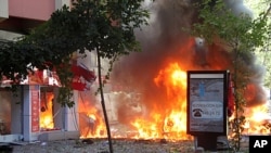 Flames are seen in a street after a blast in central Ankara. A bomb blast rocked the centre of the Turkish capital Ankara on Tuesday and some media reports said two people were killed, while a local mayor said nobody was dead but three people were serious