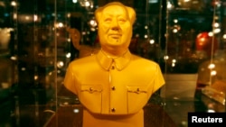 FILE - A golden bust of the late Chairman Mao Zedong.