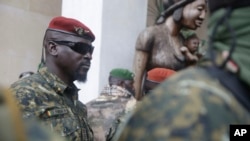 FILE - Guinea's Junta President Col. Mamady Doumbouya, centre, is heavily guarded by soldiers after a meeting with ECOWAS delegation in Conakry, Guinea Friday, Sept. 10, 2021. 