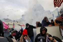 FILE - Supporters of then-President Donald Trump clash with police officers in front of the U.S. Capitol Building in Washington, January 6, 2021.